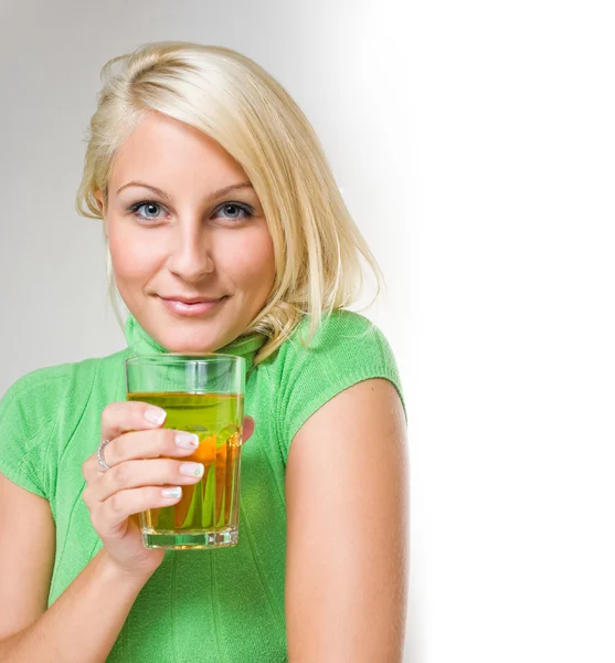 Gorgeous young blond with glass of juice. — Stock Photo, Image