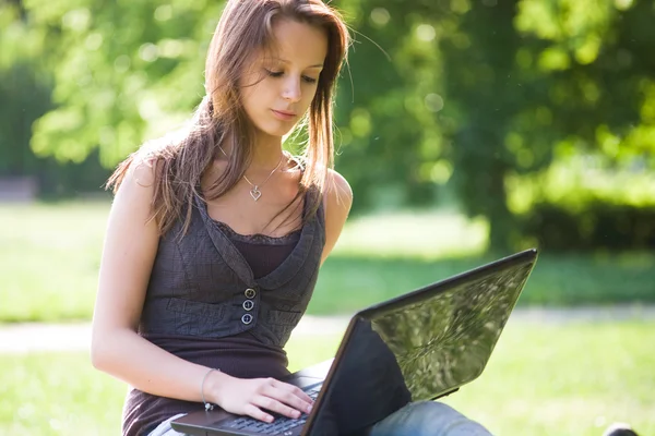 Young brunette girl with her latop. — Stock Photo, Image