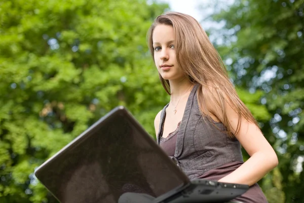 Brunette cutie and her laptop. Royalty Free Stock Images