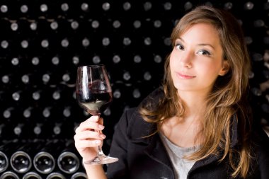 Beautiful young woman tasting wine. clipart