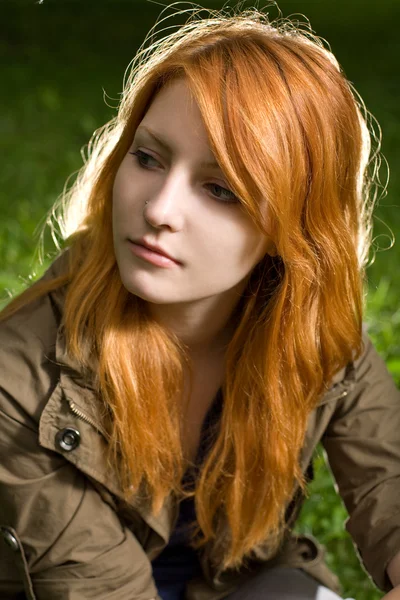 Romantic closeup portrait of a young redhead girl sitting in the — Stock Photo, Image