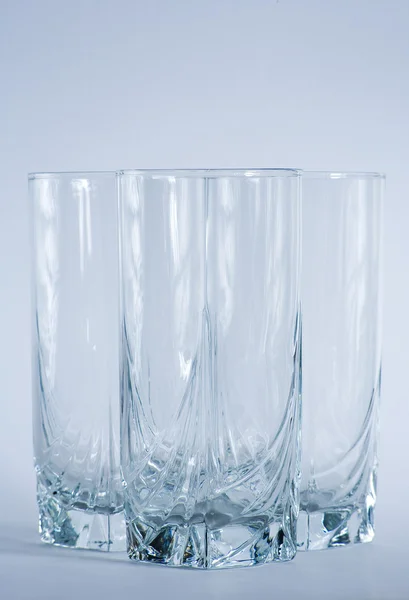 Decorative drinking glasses shot in cool blue filtering. — Stock Photo, Image