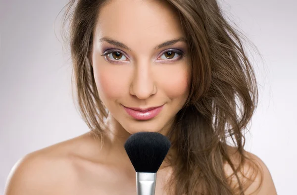 Cosmetics concept with beautiful brunette woman. Royalty Free Stock Photos
