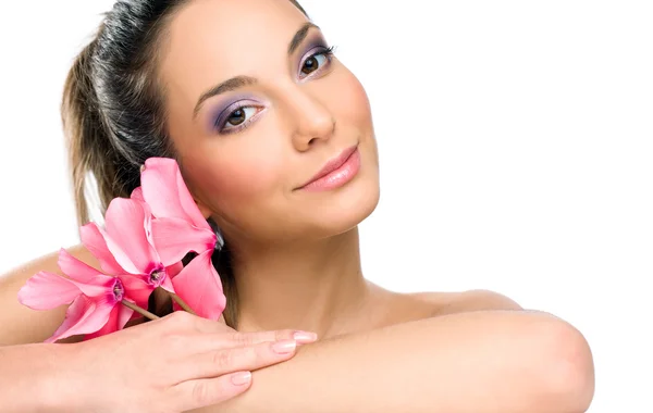 Brünette Wellness-Schönheit mit rosa Blüten — Stockfoto