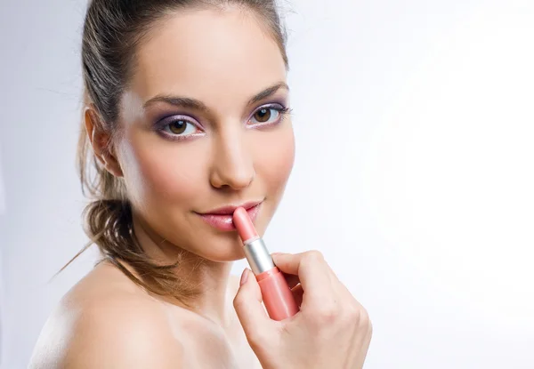 Pretty young brunette with lipstick. — Stock Photo, Image