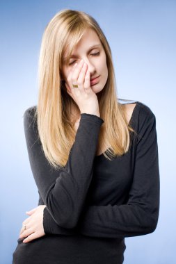 Sad looking young blond woman. clipart