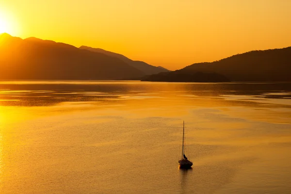 stock image Lonely boat in the sea on sunrise