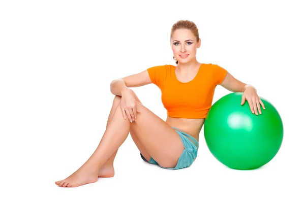 Pretty blond girl making sport with a ball — Stock Photo, Image