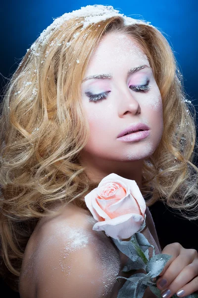 La muchacha hermosa rubia con los cosméticos invernales y la rosa sobre blu — Foto de Stock