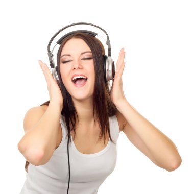 Beautiful girl listens to music through ear-phones clipart