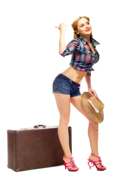Pretty young happy woman with travel bag and hat waits — Stock Photo, Image