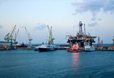 Cranes and boats in Naples sea port on sunrise clipart