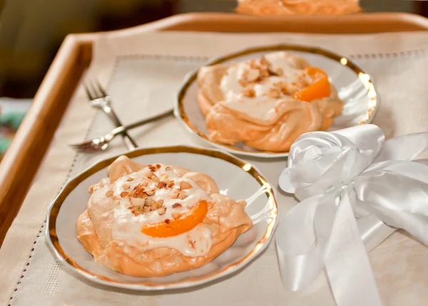 stock image Fresh meringue with thick cream and slice of peach on a plate