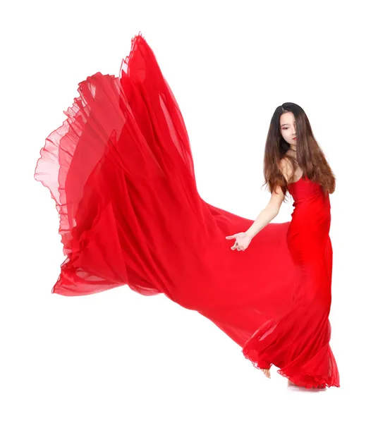 Junge Frau in fließendem roten Kleid auf weißem Hintergrund — Stockfoto