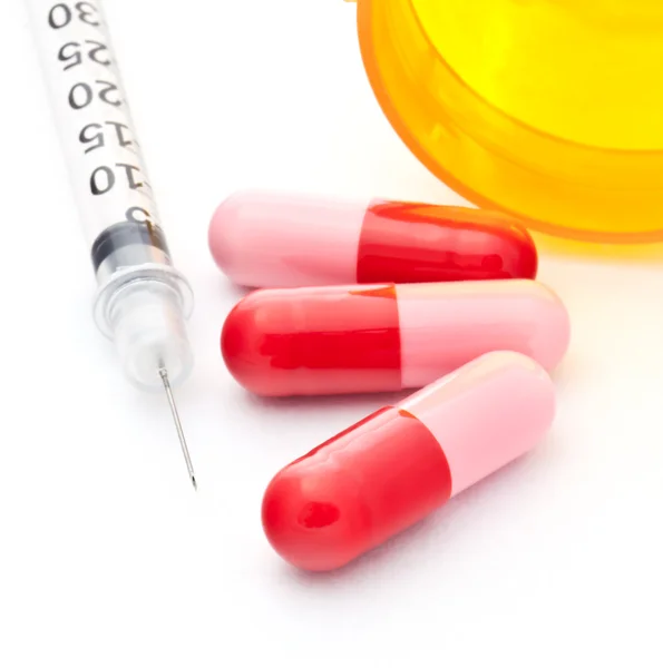 Syringe and Three Red Capsules — Stock Photo, Image