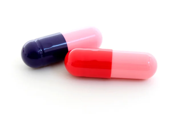 Blauwe en rode capsules — Stockfoto