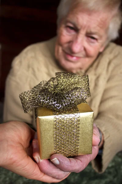 Senior houden een doos van de gift — Stockfoto