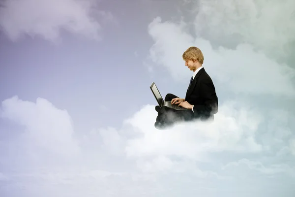Using a laptop in the clouds — Stock Photo, Image
