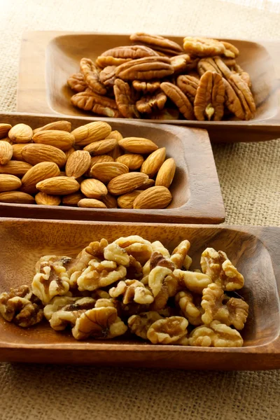 Nuts in wooden plates — Stock Photo, Image