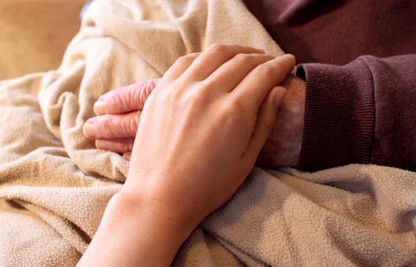 Old and Young Hands on Brown Blanke — Stock Photo, Image