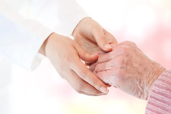 Läkare anläggning senior damens hand — Stockfoto