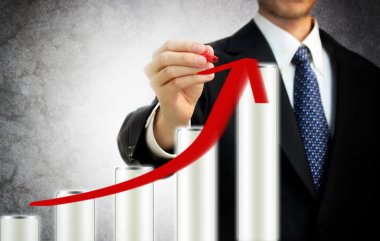 Businessman drawing a rising arrow representing growth clipart