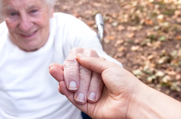 Senior och ung kvinna som håller hand — Stockfoto