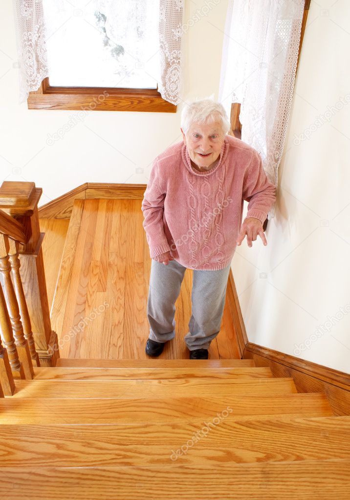 Senior woman in front of staircase