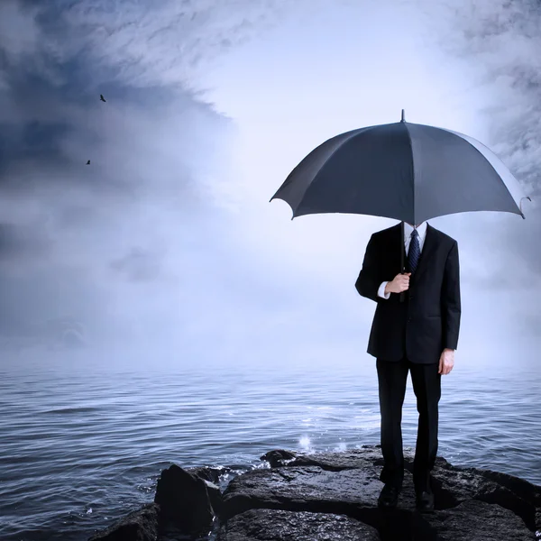 Mann mit Regenschirm an der Küste — Stockfoto