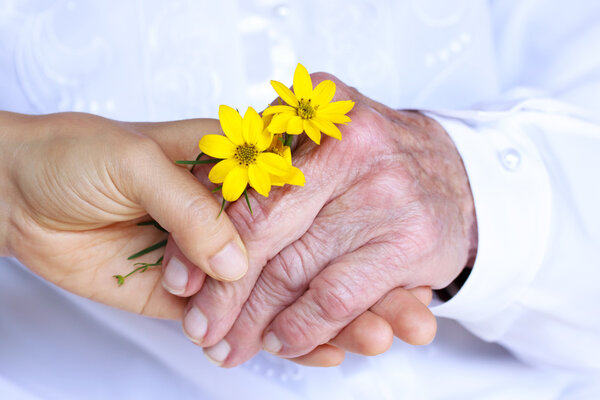 Senior and Young Ladies Holding Hands