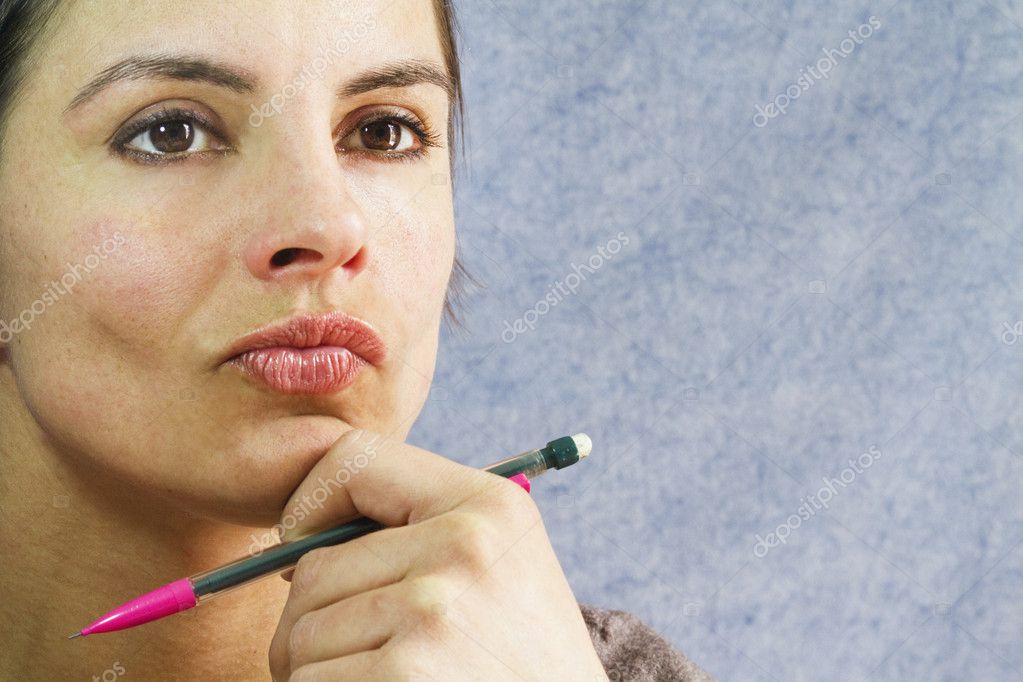 doubtful-woman-with-pencil-in-her-hand-9860946-larastock