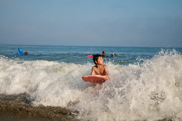 Asian Boy surfing in summer
