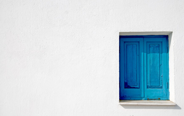 Blue church window on a white wall from a church in Cyprus