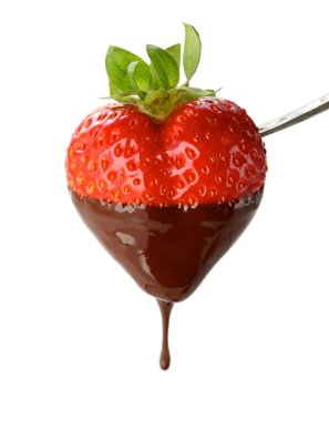 A heart shapped strawberry dipped in chocolate fondue