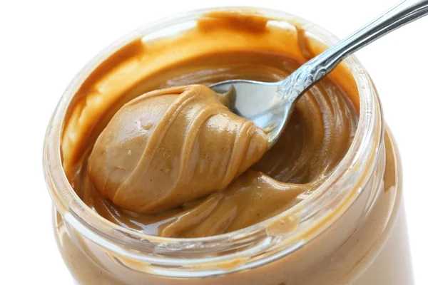 An open jar of peanut butter with spoon — Stock Photo, Image