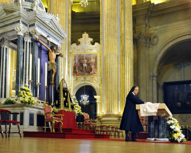 Roman Catholic nun preparing the altar clipart