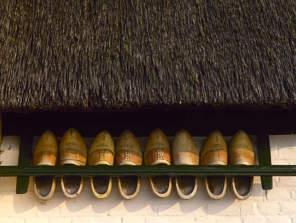 Wooden shoes under a reed roof — Stock Photo, Image