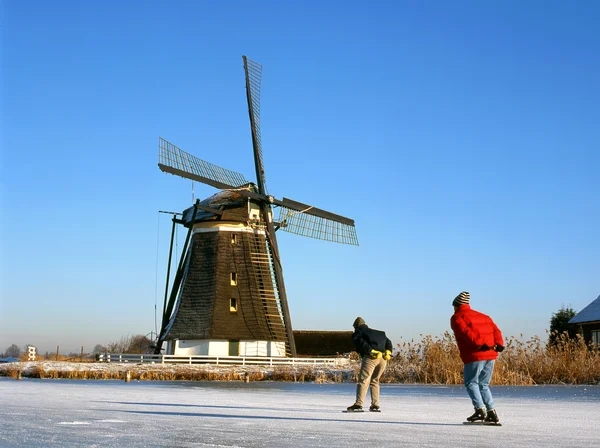 Windmill and skaters — Stock Photo, Image