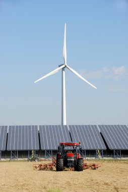 Solar plant with wind turbine at farm clipart