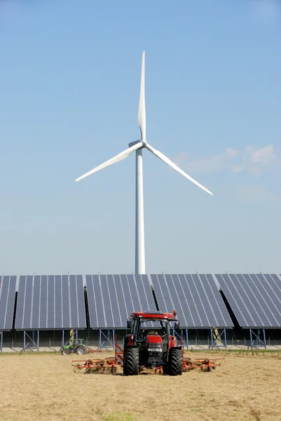 Solar plant with wind turbine at farm — Stock Photo, Image