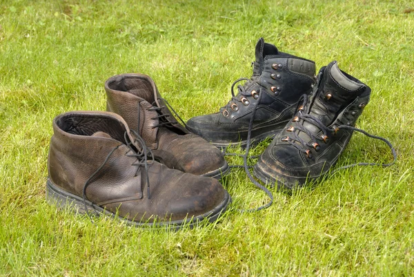 stock image Two pair of old worn walking boots