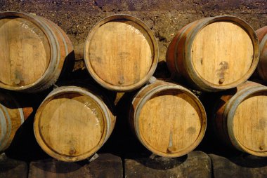 Old wine cave with wooden barrels clipart