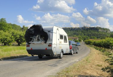 Car with caravan on its way clipart