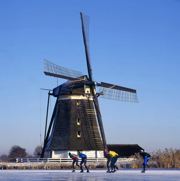 Moinho de vento e patinadores — Fotografia de Stock