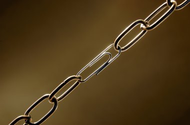 Weak chain with a paper clip clipart