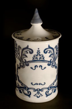 Antique ceramic canister on black background. Typical in Europea clipart