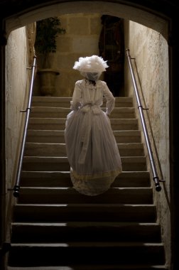 Victorian lady in castle stairs. 1900 Style.