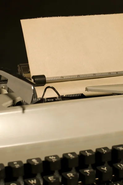 Vintage typewriter with paper sheet inside on black background — Stock Photo, Image