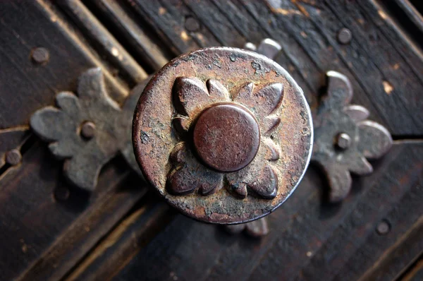 Old metallic decoration motif on a wooden door — Stock Photo, Image