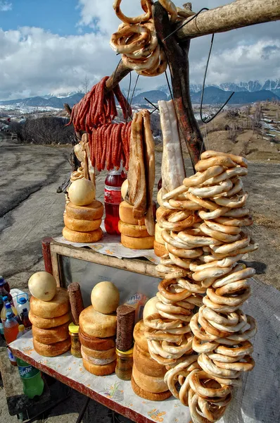Hanging smoke-dried sausage, cheese and pretzel — Stock Photo, Image
